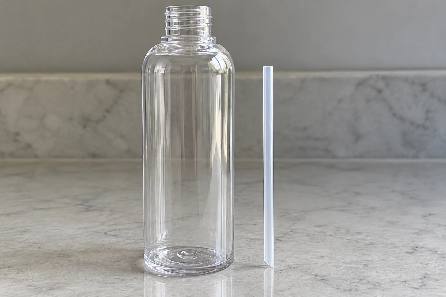 Example dip tube beside an empty clear bottle, shorter than the bottle interior